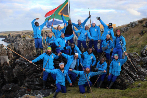 MARION 71 (2014-2015): Back (L-R) Yinhla Shihlomule (MRI Sealer), Louise Gadney (Medic), Mpho Mphego (SANSA Engineer), Liezl Pretorius (MRI Sealer), Zuko Nkomo (Oceans & Coasts Birder), Gerard de Jong (Radio Technician), John Skelete (Diesel Mechanic/Radio Technician); Row 2 (L-R): Alexis Osborne (PFIAO Birder), Josef Klansen (Senior Meteorologist), Rendani Mikosi (Assistant Environmental Control Officer), Johannes Masingo (Meteorologist), Geneveive Moroke (Oceans & Coasts Birder), Low de Vries (MRI Sealer); Row 3 (L-R): Frank Venter (Meteorologist/Team Leader), Ishmail Games (Base Engineer), Tshilidzi Ramagoma (Environmental Control Officer), Vonica Perold (PFIAO Birder); Front (L-R): Daniël Kotzé (MRI Killer Whaler), David Green (Oceans & Coasts Birder).