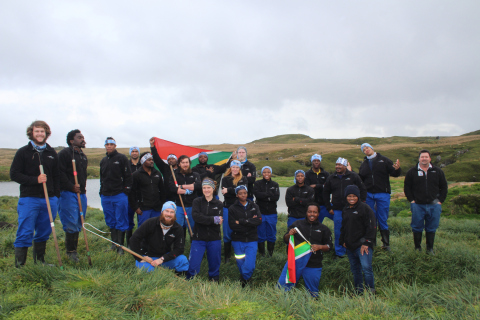 MARION 74 (2017-2018): (L-R) Rowan Jordaan (Killer whaler/sealer), Yinhla Shihlomule (Sealer), Tuna Shabangu (Diesel mechanic), Sherwin Hiralall (Medical Orderly), Maanda Benjie Raselabe (Botanist), David Green (NMU/MAPRU Birder), Odwa Obose (Botanist), André van Tonder (Sealer), Sibusiso Gumede (Environmental conservation officer), Cara-Paige Potter (Oceans and Coasts Birder), Michelle Jones (FIAO Birder), Christopher Jones (FIAO Birder), Nthabiseng Elsie Chelsea Mekwa (Assistant Meteorological Technician), Sinazo Maneli (Assistant Meteorological Technician), Kagiso Malepe (Space Weather Engineer), Thando PJ Cebekhulu (Oceans and Coasts Birder), Aubrey Nonyana (Environmental conservation officer), Lucas Mabule (Base Engineer and Team leader), Jerry Ramonyai (Senior Meteorological Technician), Sibusiso Sinuka (Geomorphologist), David Hartzenberg (Communications engineer).