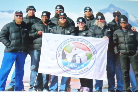 SANAE 51 (2012): Back (L-R) Vincent Rademeyer (Diesel Mechanic & Deputy Team Leader), Johan Du Plessis (Mechanical Engineer), Braam Beukes (SANSA Space Weather Engineer), Singa Msimanga (Electrical Engineer); (front) Jaco Bester (Doctor & Team Leader), Avhavhudzani Michael Nemutandani (Diesel Mechanic), Jonathan Ward (SANSA Radar Engineer), Stefanie Stracham (NWU Cosmic Ray Engineer), Elrich Delport (Communications Technician), Mcabango Biyela (SAWS Meteorologist).